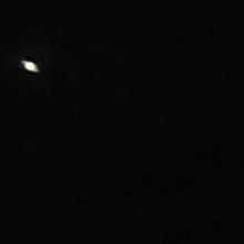 Low quality image of an extremely tiny Saturn taken from a basic telescope.