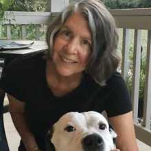 Woman with short hair and her white dog
