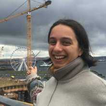Photo of woman in front of ferris wheel. 