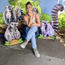 Sitting with cardboard cutouts of cool lemurs.