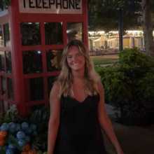 A photo of me outside a telephone booth. Una foto de mí afuera de una cabina telefónica.