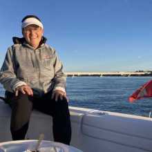 Helen sitting on a boat