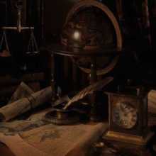 Background of a desk filled with books and a globe in an almost sepia light.