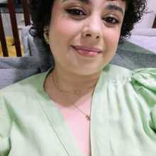 A woman with curly black hair 