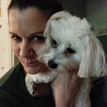 A woman with a dog in a hug