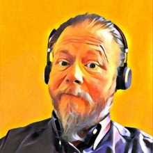 Sparky, headshot, with headphones on.