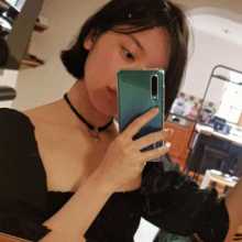 British asian girl taking a mirror selfie