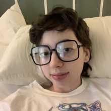 A picture of me. Brown hair wearing large glasses