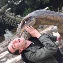 A man being attacked by a dinosaur