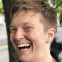 white woman with short hair looking joyful