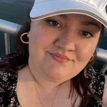 Woman in a white hat and black shirt 
