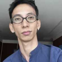 picture of an asian guy in glasses and a blue button up shirt