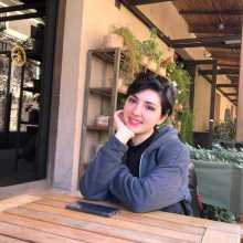 A woman with pretty short dark hair, 20 years old.