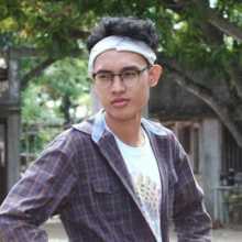 Person outdoors in plaid shirt and headband, casual vibe.