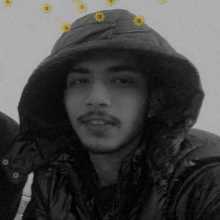 Person wearing a hoodie, looking at the camera.”