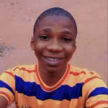 Person studying a foreign language on a laptop with books and notes around.