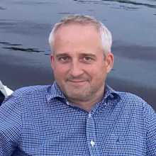 A smiling man on a boat