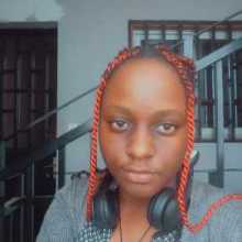 selfie picture of me (dark skinned girl with braids sitting on a staircase)