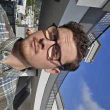 image of me outside in a shopping center with a flannel shirt