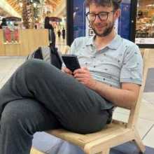 A handsome man reading with his phone.