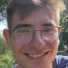 Portrait photo of me smiling outdoors.