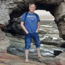 Me by a hole in a rock on the beach