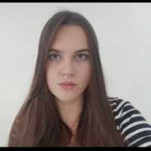 Girl is sitting in the front of camera; with makeup and in good mood (in black and white shirt)