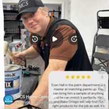Man smiling working at a paint counter.