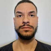 man with beard and no smile looking at the camera