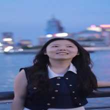 Young woman portrait against city waterfront night view