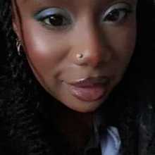 Black girl with black twist, wearing blue eyeshadow 