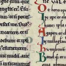 A patch of scribal text from a manuscript page produced ca. 1000 - 1050. The illuminated letters are simple, coloured in red or green. 