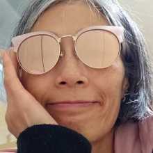 A person with a grey bob haircut and sunglasses