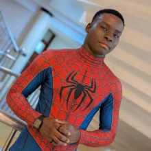 A young man wearing a red and blue Spider-Man suit posing for a profile photo