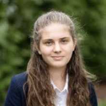 girl with long hair, wearing a blue blazer and white shirt