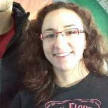 Profile Image - American woman with brown hair and glasses
